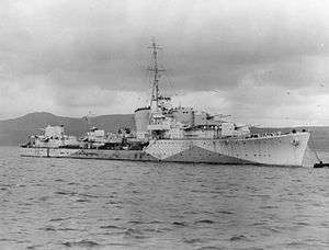 a black and white photograph of a warship at sea